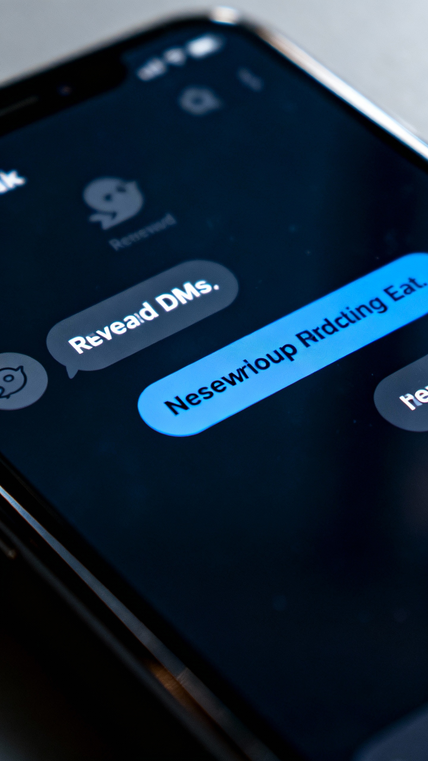 Closeup of smartphone screen with unread DMs, muted notifications, dark mode