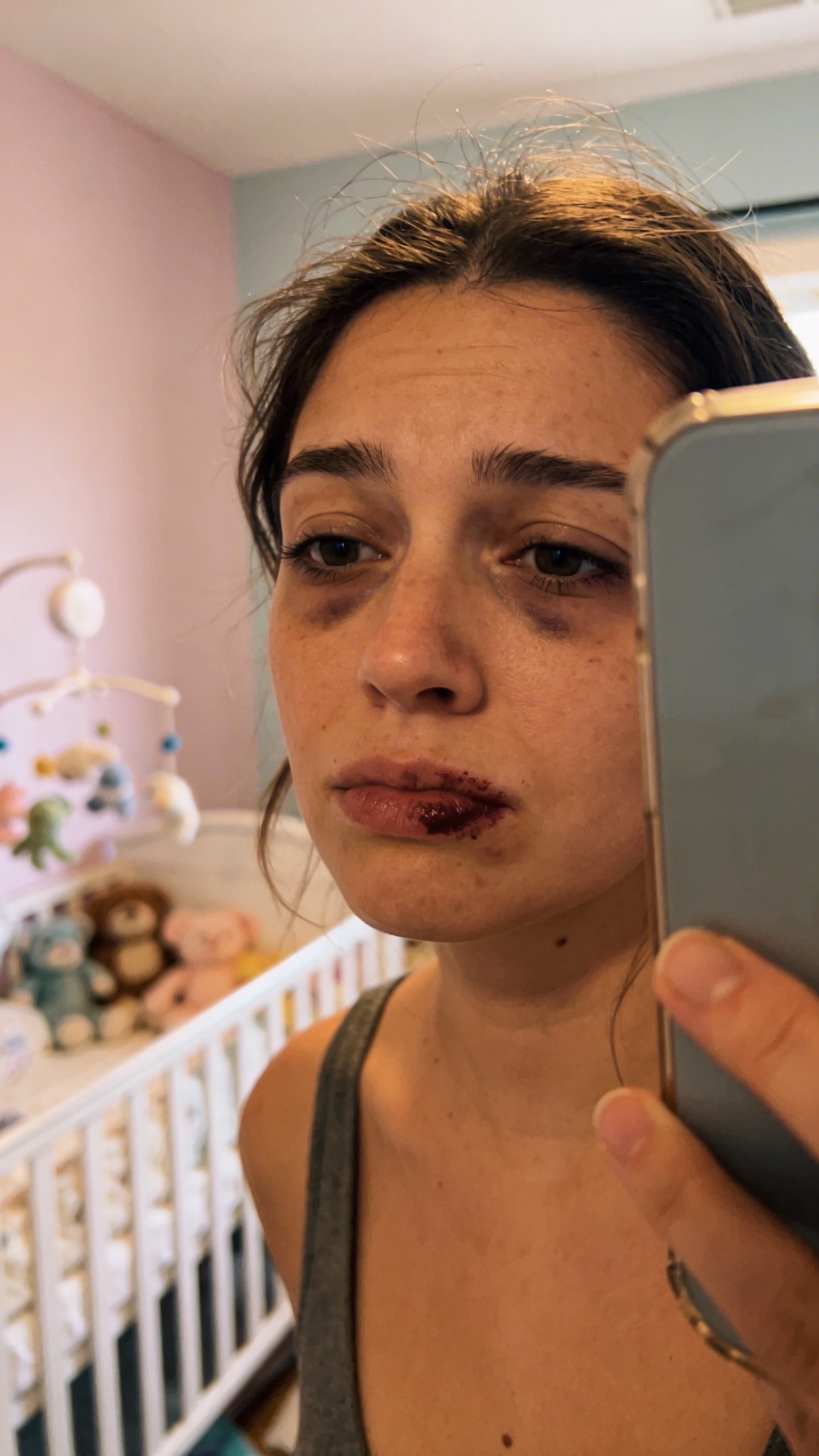 Mirror selfie of tired mom, smeared lipstick, nursery background