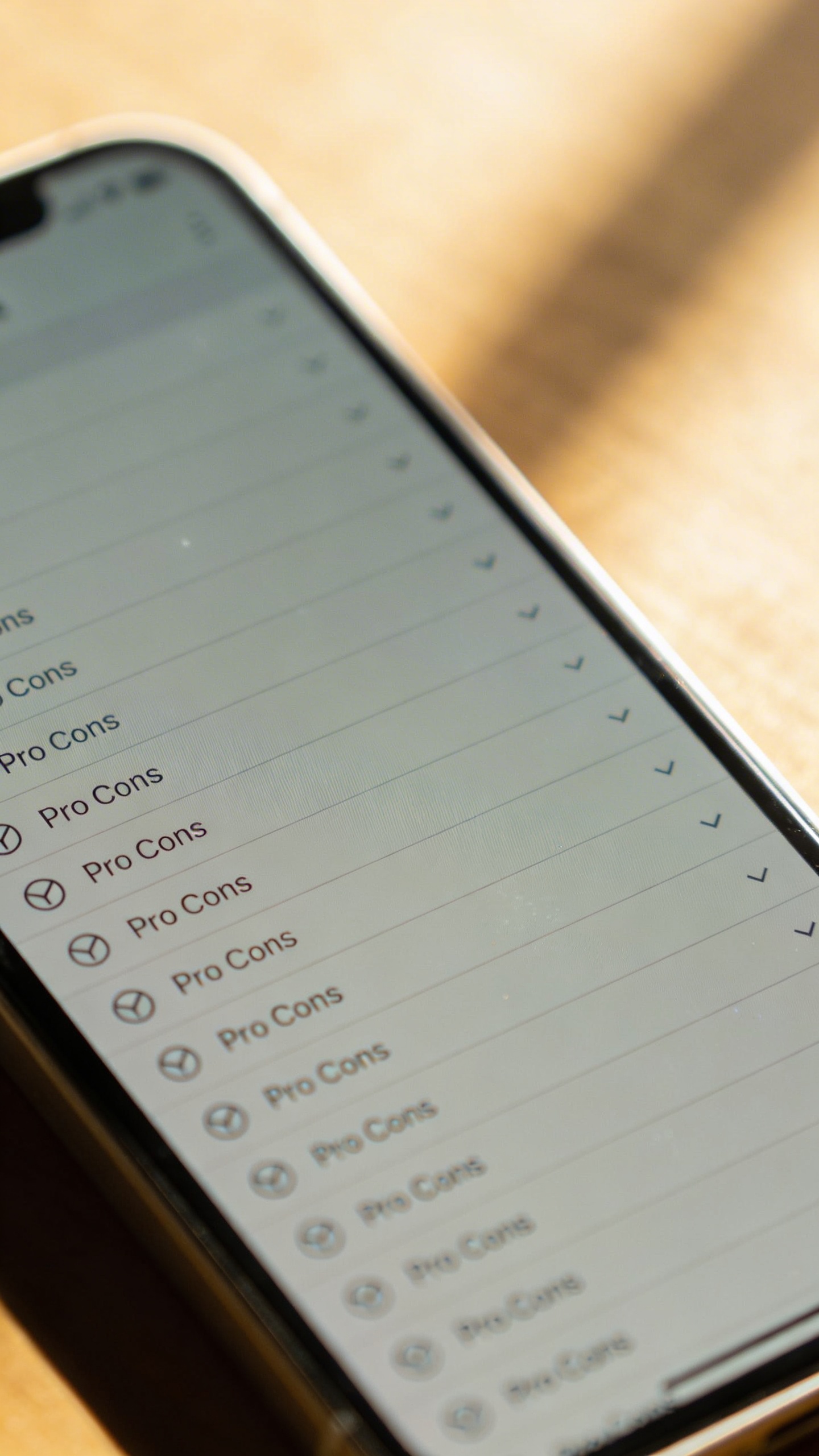 smartphone screen with endless pro-con list, soft daylight