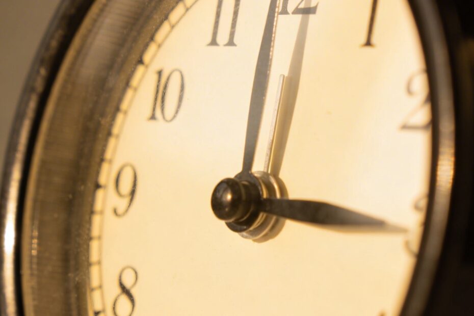 closeup of a single analog alarm clock at 6pm cutoff