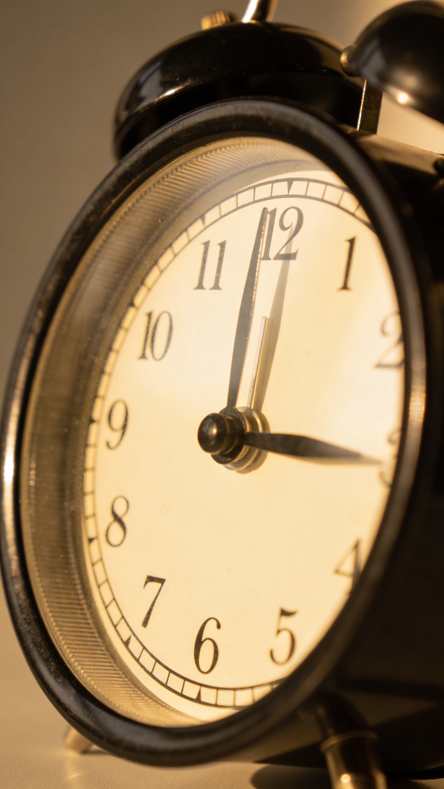 closeup of a single analog alarm clock at 6pm cutoff