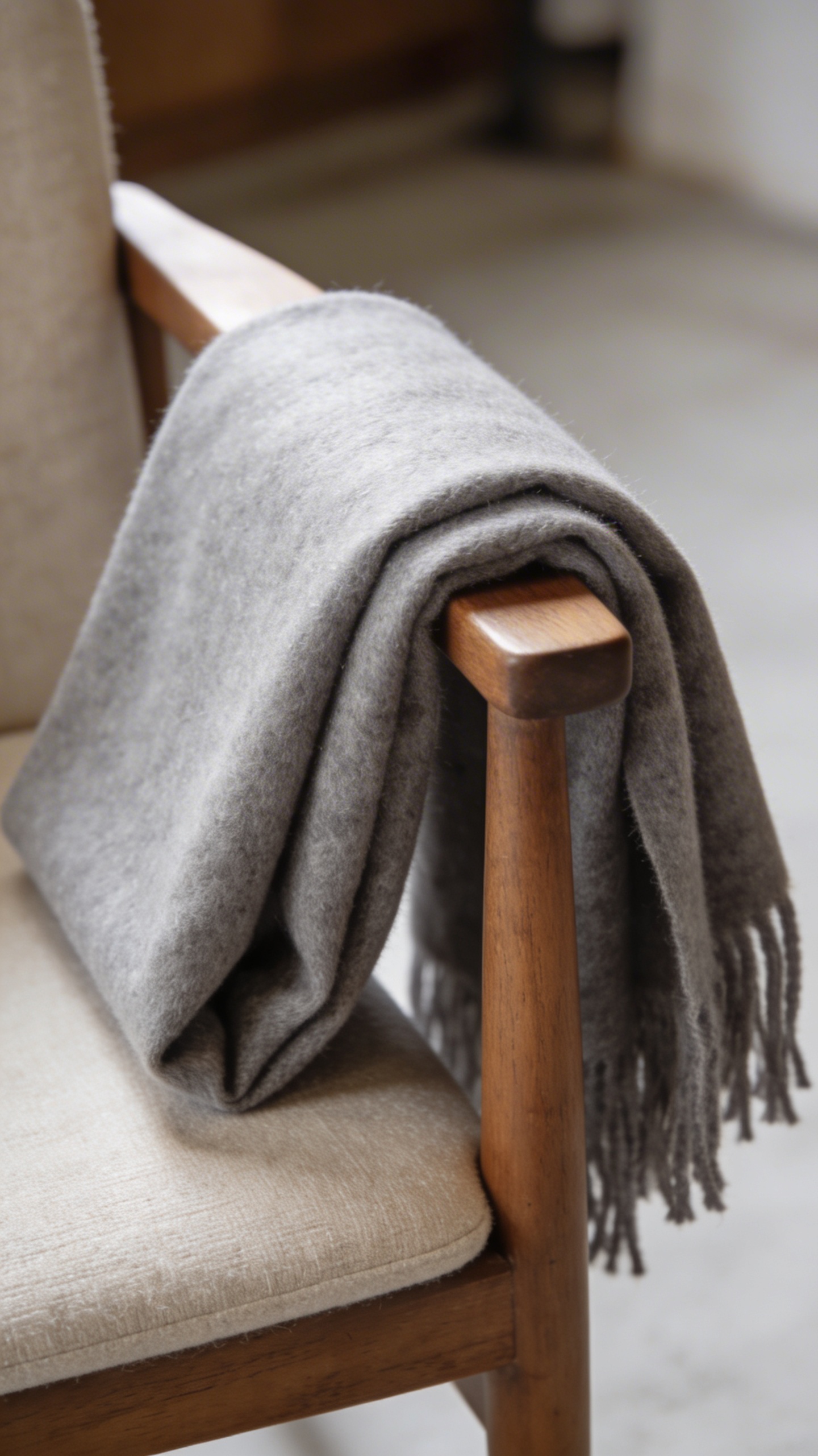 closeup of plush grey cashmere throw folded on chair arm
