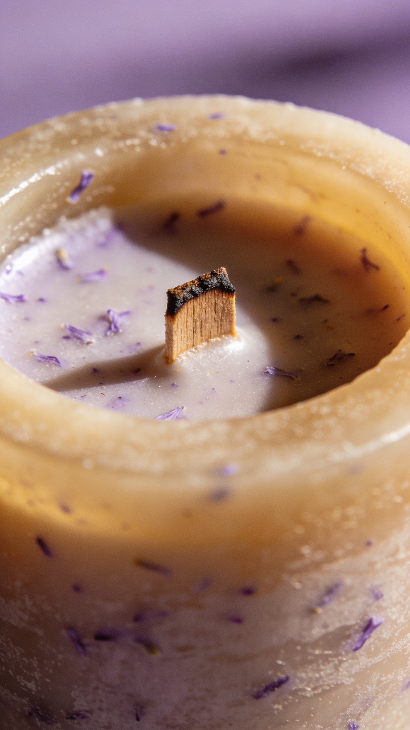 macro shot of lavender soy candle with wooden wick