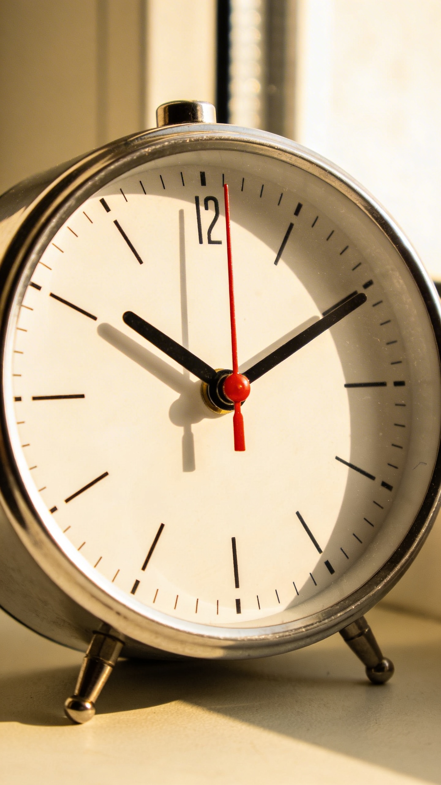 minimalist analog alarm clock set to 10 minutes, soft window light