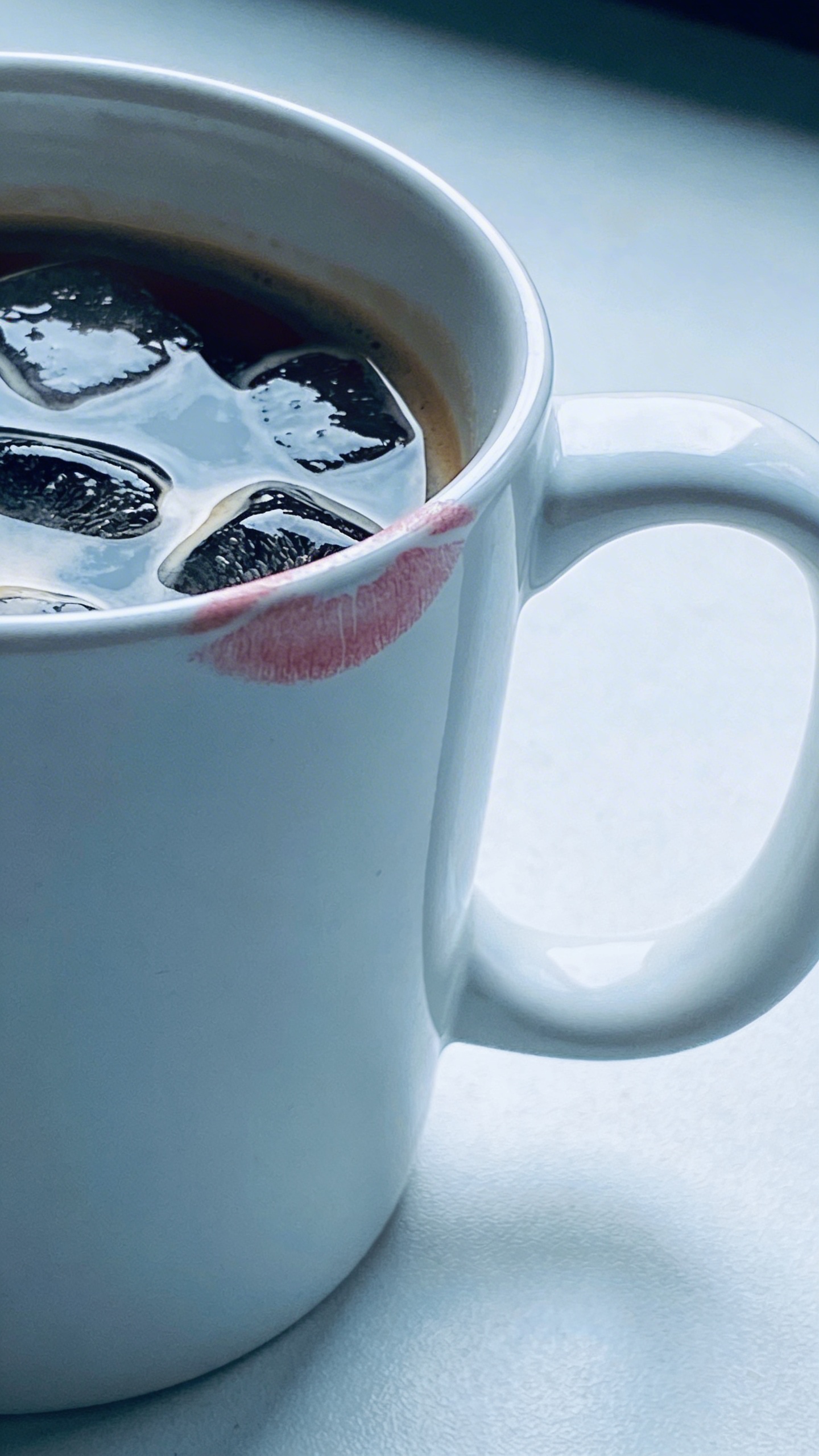 single cold coffee mug with lipstick mark on rim