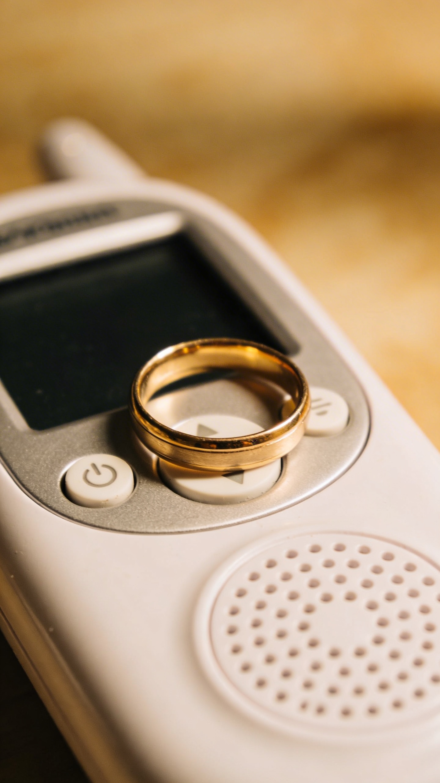 closeup of a single wedding ring on a baby monitor