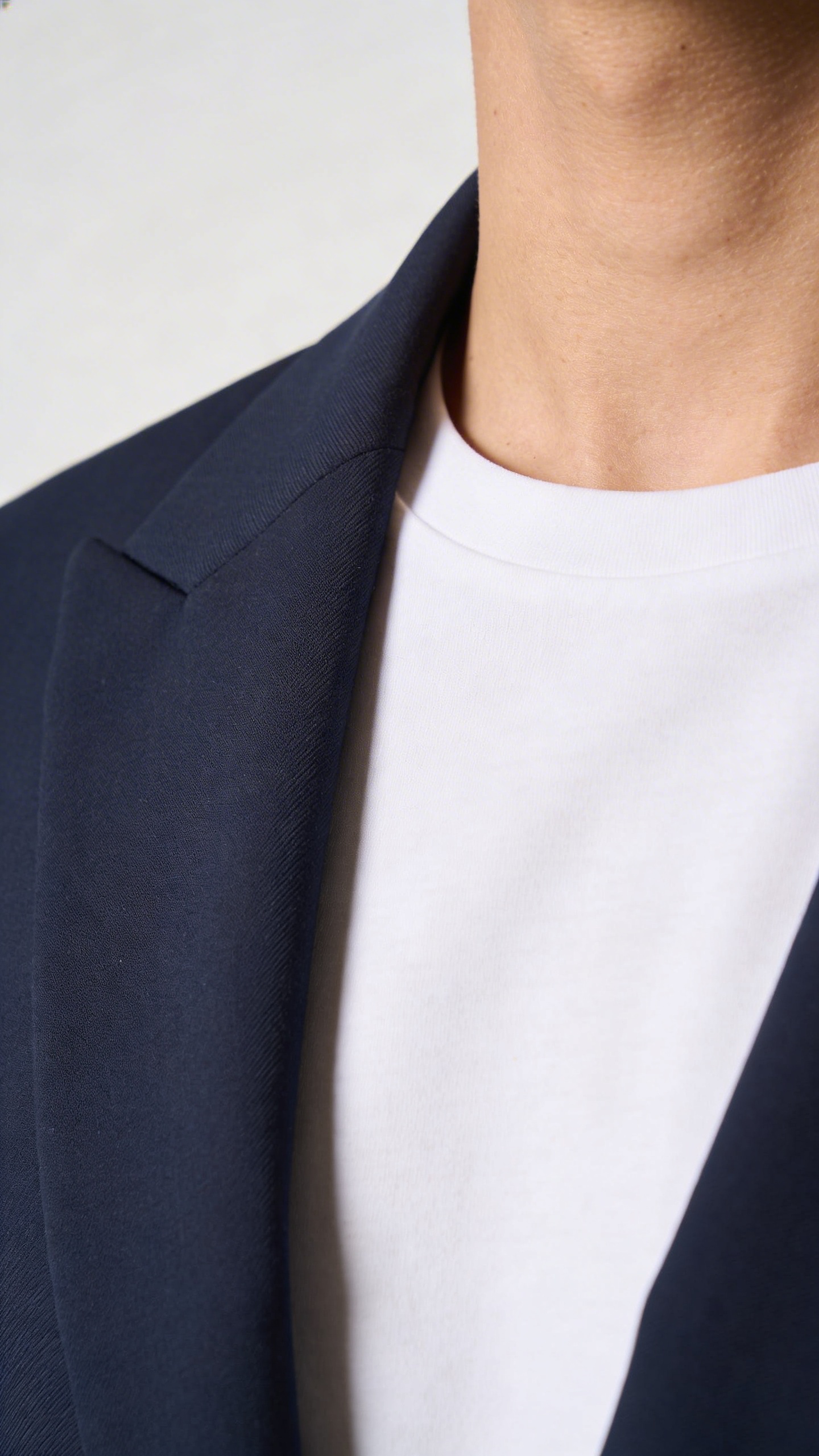 closeup navy blazer lapel with sharp white tee contrast